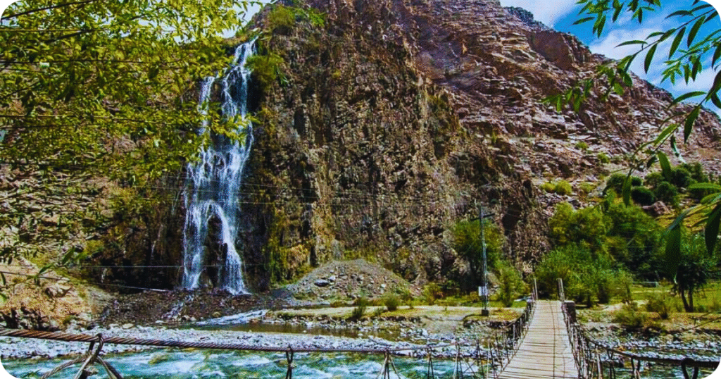“Top best places to visit in Skardu: Manthokha Waterfall cascading through lush greenery.”