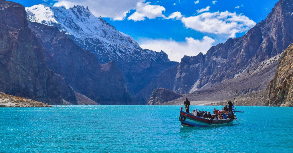 Attabad Lake in Hunza with bright blue water surrounded by rocky mountains.