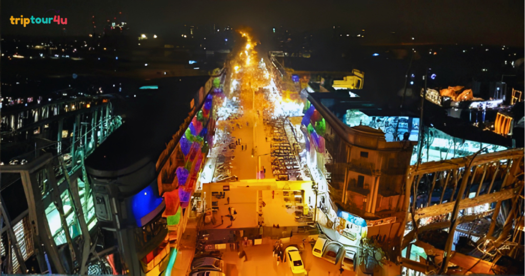Burns Road Karachi at night, showing a lively street filled with famous food stalls, restaurants, bright lights, and crowds enjoying traditional Pakistani cuisine.