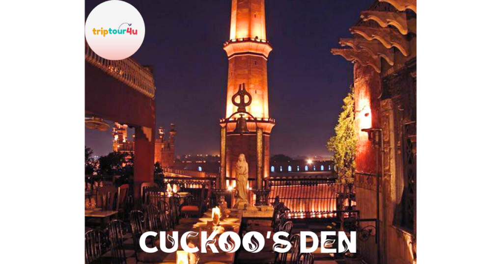 Cuckoo’s Den rooftop restaurant at night in Lahore, featuring candlelit tables with a view of the illuminated Badshahi Mosque minaret and historic Fort Road surroundings.