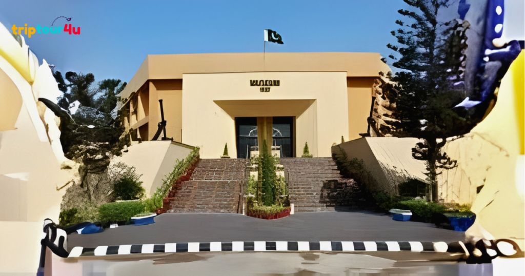 Front view of Pakistan Maritime Museum in Karachi, showcasing the main entrance building with naval architecture, landscaped surroundings, and a clear daytime sky