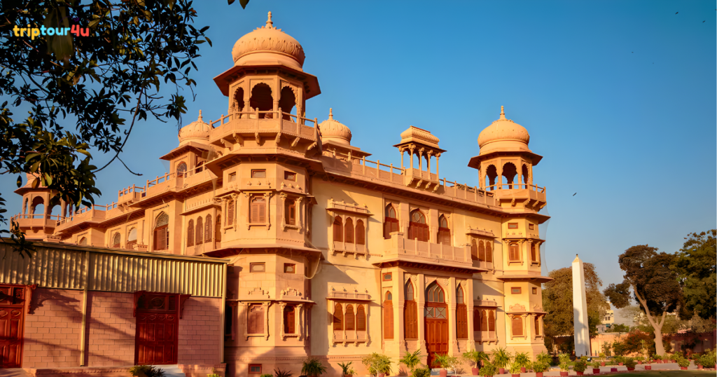Mohatta Palace in Karachi showcasing Indo-Saracenic architecture with ornate domes, arched windows, and warm sandstone tones under a clear blue sky.