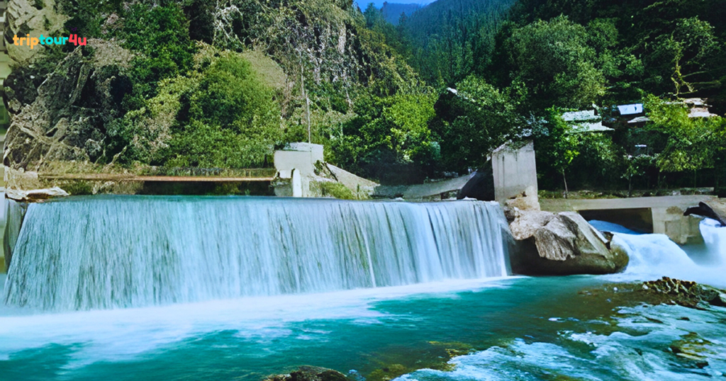 Kutton (Jagran) Waterfall in Neelum Valley, Pakistan, cascading through lush green forested hills with clear flowing water and rocky surroundings.