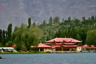 Shangrila Lake Skardu with red-roof resort surrounded by lush green trees and mountains, featured image for Skardu Tour Packages 2026