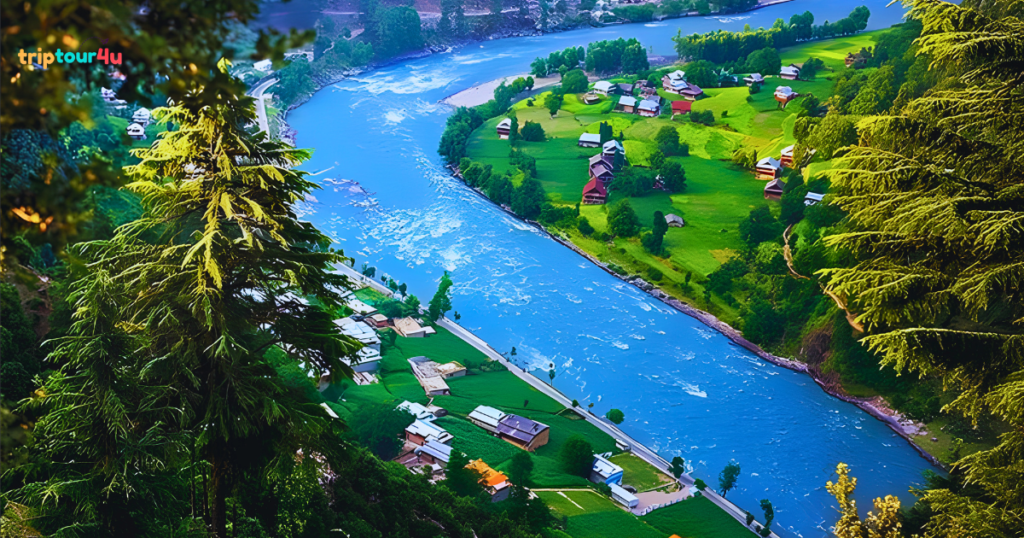 Kel town in Neelum Valley, Pakistan, featuring lush green hills, traditional buildings, the Neelum River, and surrounding mountains under a clear sky.