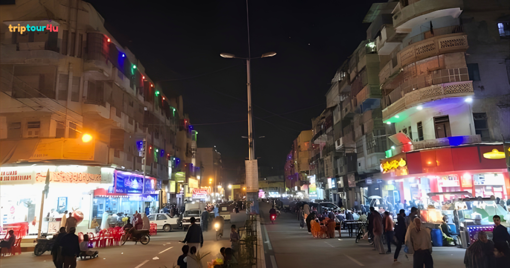Burns Road Karachi street food scene with crowded food stalls, traditional restaurants, and bustling nightlife atmosphere.