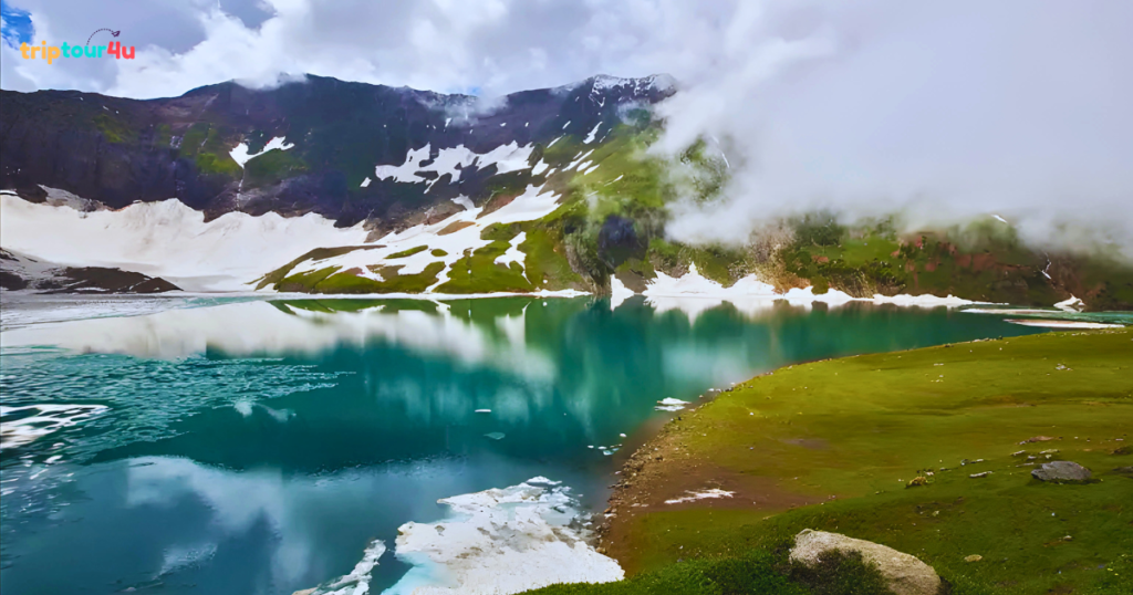 Breathtaking view of Ratti Gali Lake in Neelum Valley, Pakistan, surrounded by snow-capped mountains and colorful alpine meadows with crystal-clear turquoise water.