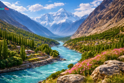 Turquoise river flowing through Gilgit-Baltistan valley with snow-capped mountains, green forests, terraced villages, and clear blue sky.