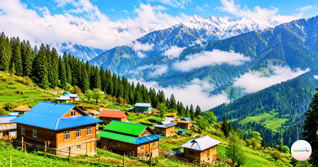 Arang Kel Village in Neelum Valley with its colorful wooden houses, green pastures, pine forests, and misty mountains in Azad Kashmir, Pakistan.