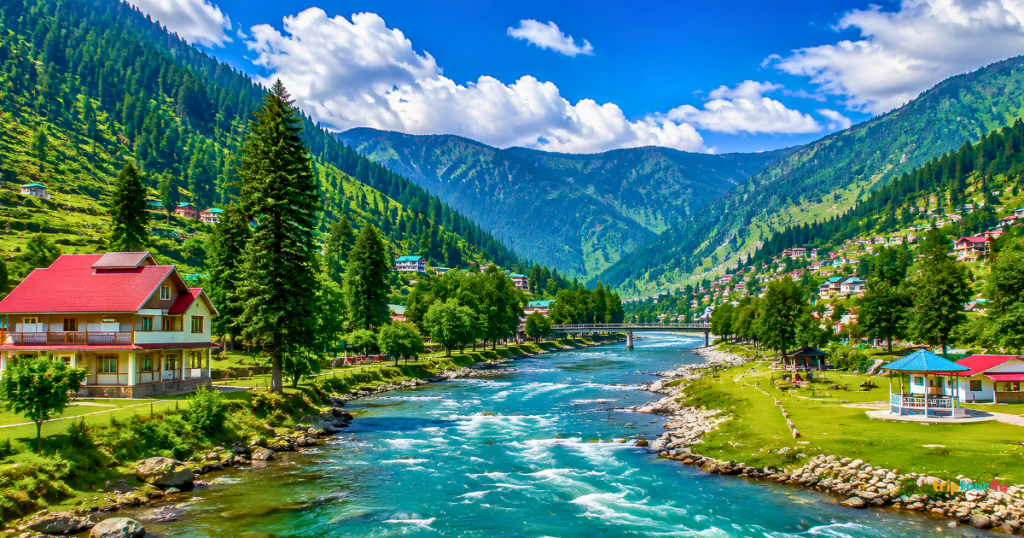 Scenic landscape of Azad Jammu and Kashmir featuring a crystal-clear river, lush green valleys, pine forests, charming hillside villages, and majestic mountains under a bright blue sky.