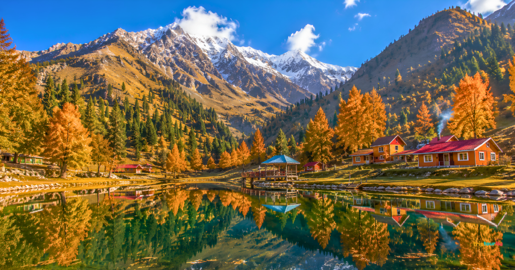 Autumn scenery in Naran, Kaghan, and Shogran featuring a mirror-like alpine lake, golden meadows, colorful wooden cabins, evergreen forests, and snow-capped mountains under a clear blue sky.